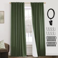 a living room with green drapes and black rings on the curtain rod, in front of a window