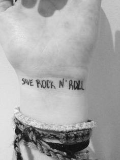 someone with a tattoo saying save rock'n'roll on their left arm and wrist