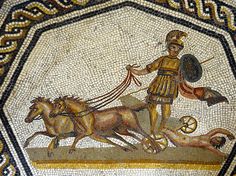 an ancient roman mosaic with a man on a chariot being pulled by two horses