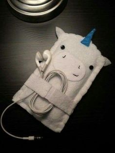 an ipod case with a unicorn on it and a charger plugged into the side