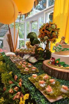 a table filled with lots of food and balloons