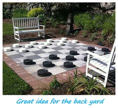 a checkerboard chess board sitting in the middle of a yard