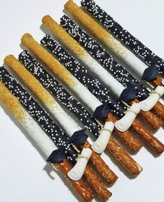 several different types of sticks with white and blue decorations on them are arranged in a row