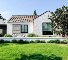 a white house sitting on top of a lush green field