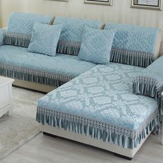 a living room with blue couches and white coffee table in front of the window