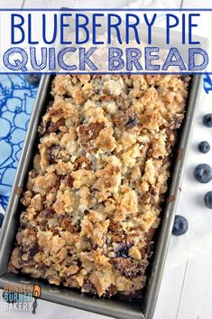 a pan filled with blueberry crumbled oatmeal next to fresh blueberries