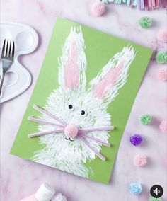 an easter bunny card made with crepe paper and colored pom poms