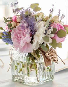 a vase filled with lots of flowers on top of a table