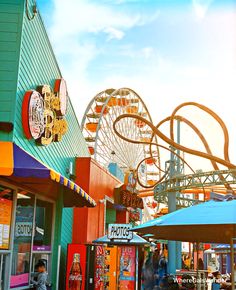 an amusement park with people walking around