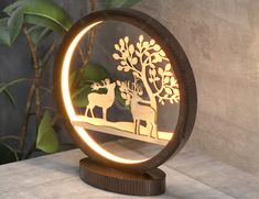 an illuminated deer and tree stand on a table