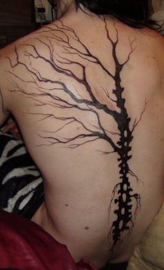 a woman with a tree tattoo on her back