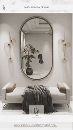 a white room with a round mirror on the wall and a bench in front of it