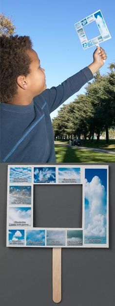 a young boy holding up a polaroid with photos on it and clouds in the background