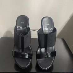 Elevate Your Shoe Collection With These Stylish Italian Shoemakers Women's Sandals In Black. Perfect For Any Occasion, From Travel To Workwear, These Slip-On Sandals Feature A High Wedge Heel Measuring Between 3-3.9 Inches, Providing A Comfortable And Trendy Look. The Sandals Are Designed With A Slip-On Closure For Ease Of Wear And Are Available In Us Shoe Size 5.5 Stretch Fabric New No Tags No Box Never Used Black Wedge Heel Sandals Medium Width, Black Medium Width Wedge Heel Sandals, Black Wedge Sandals With Removable Insole, Black Wedge Heel Sandals With Removable Insole, Black Slip-on Wedge Sandals, Black Sandals With 4-inch Wedge Heel, Elegant Black Wedge Sandals With Open Heel, Black Synthetic Medium Width Wedge Sandals, Black Wedge Sandals With Heel Loop