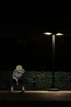 a person sitting on a bench in the dark