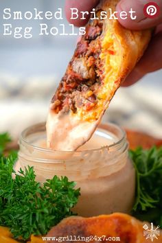 a person dipping some food into a jar