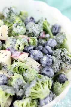 a bowl filled with broccoli and blueberries