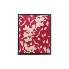 a red and white floral print with black frame on the wall above it is an image of flowers