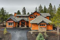 this is an image of a large house in the woods with lots of trees around it