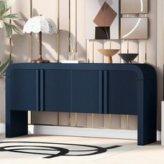 an art deco console table in blue and gold with modern artwork on the wall behind it