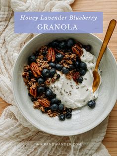 a bowl filled with granola topped with blueberries and pecans