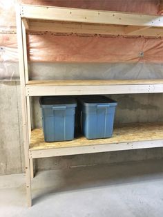 two plastic buckets sitting on top of a shelf in a room that is under construction