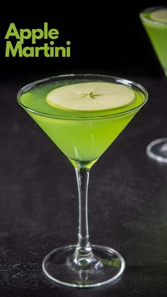 an apple martini is garnished with a slice of apple on the rim and served in coupe glasses