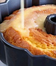 a cake in a pan being drizzled with icing