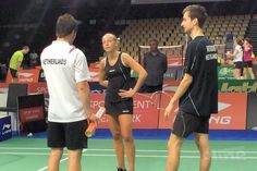 two tennis players talking to each other on the court