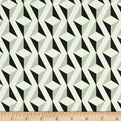 a black and white pattern on fabric with a ruler in the foreground, it's diagonal shape