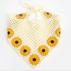 a crocheted bib with sunflowers on it