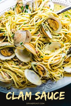 pasta with clams and sauce in a white bowl on a blue tablecloth, ready to be eaten