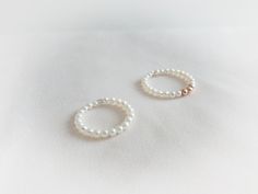 This gorgeous  delicate pearl ring is made with premium crystal pearls in white. This listing is for one ring with crystal pearls and sterling silver beads/ gold filled bead or rose gold filled beads. it is great for stacking with other rings. Dimensions: pearl size : 3mm round pearls Sterling silver Beads : 3mm  Gold filled Beads : 3mm Rose Gold Beads: 3mm " Please select your ring size when you checkout " Minimalist Adjustable Ring With Pearl Drop, Minimalist Adjustable Rings With Pearl Drop, Minimalist Adjustable Pearl Drop Rings, Minimalist Adjustable Pearl Rings, Minimalist Pearl Drop Ring For Gift, Minimalist Pearl Drop Rings As Gift, Delicate Stackable White Gold Pearl Ring, Delicate White Gold Stackable Pearl Ring, Minimalist Adjustable Pearl Ring With Charm