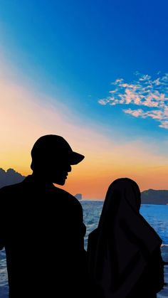 two people sitting on a bench watching the sunset