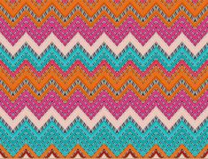 an orange, blue and pink knitted fabric with zigzag patterns on it