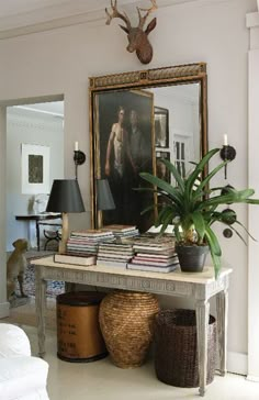 a living room filled with furniture and a painting on the wall