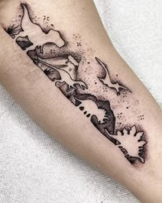 a black and white tattoo on the arm