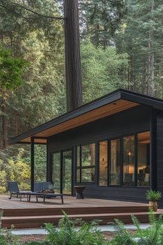 a small cabin in the woods with steps leading up to it's patio area