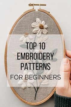 someone holding up a cross stitch embroidery pattern with the words top 10 embroidery patterns for beginners