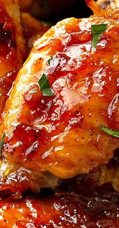 closeup of chicken wings covered in bbq sauce and garnished with parsley