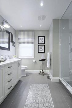 a large bathroom with two sinks and a shower