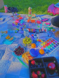 the picnic table is full of colorful food