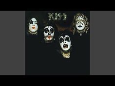 the kiss band with their faces painted white and black