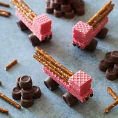 some kind of toy truck made out of pretzels and chocolates on a table