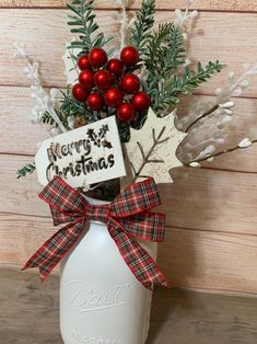 a white mason jar filled with christmas decorations