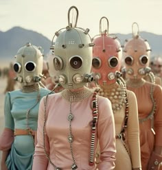 a group of people with weird looking masks on their heads and body, all wearing beaded necklaces