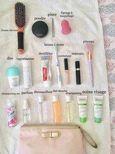 the contents of a travel bag laid out on a towel, including makeup and other personal care items