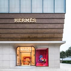 the entrance to a store with red and pink display cases on it's sides