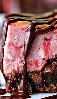 a piece of cake covered in chocolate and strawberry ice cream