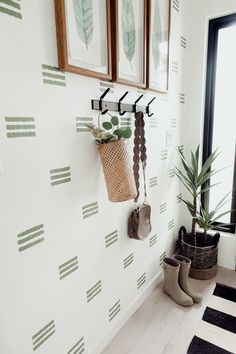 there are some plants and pictures on the wall